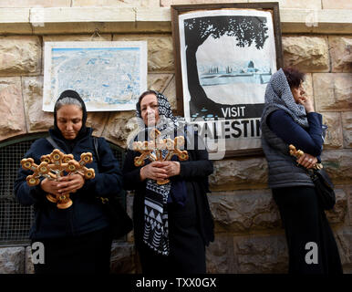 Greek Orthodox Christians hold wooden crosses during the Orthodox Good Friday procession on the Via Dolorosa, The Way of the Cross, in the Old Ctiy of Jerusalem, April 6, 2018. The Christians follow the path believed to be where Jesus Christ carried his cross to Calvary to be crucified.   Photo by Debbie Hill/UPI Stock Photo