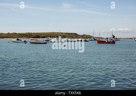 Boats moored up in the waters of the River Stour on the coast of Mudeford Spit, near Christchurch Harbour in Dorset Stock Photo