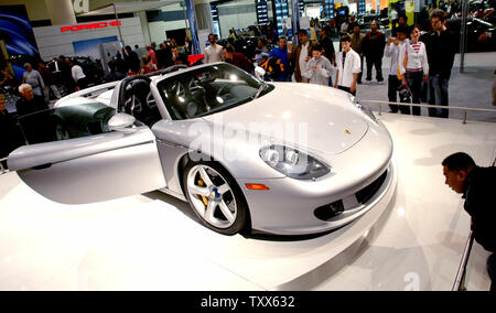 Visitors look at the Porsche Carrera GT at the 48th Annual San Francisco International Auto Show in San Francisco on November 26, 2005. There are almost 800 cars from 40 manufacturers on display at the show.  (UPI Photo/Ken James) Stock Photo