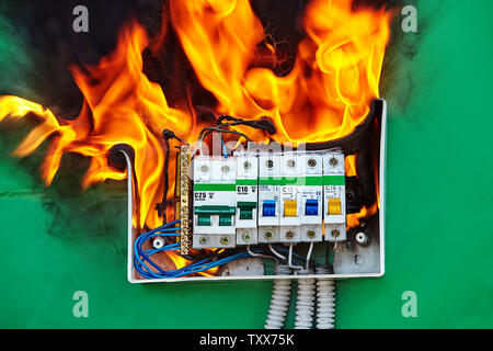 Defect of electrical distribution panel with circuit breaker is the cause of a fire in the apartment. Electrical failures and malfunctions are a facto Stock Photo