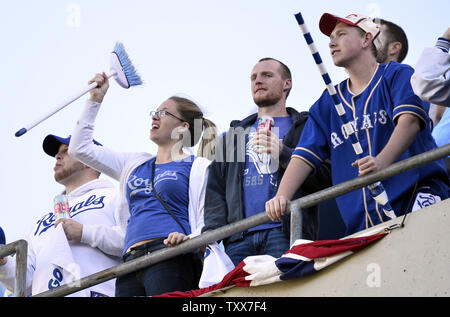 Kansas City Royals fans hold up pictures of starting pitcher Johnny Cueto  and catcher Salvador Perez as he Royals face the New York Mets in game 2 of  the World Series at