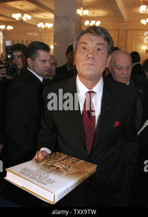 Ukrainian President Viktor Yushchenko just bought a book about Ukrainian clothes after a parliament session in  Kiev, February 9, 2006. Yushchenko makes his annual state of the nation address in parliament. (UPI Photo/Sergey Starostenko) Stock Photo