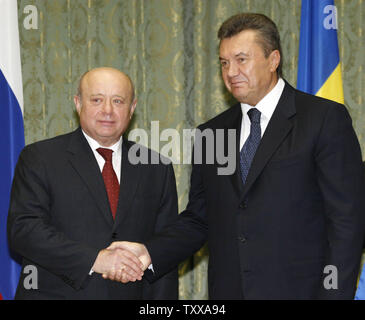 Russian Prime Minister Mikhail Fradkov (L) shakes hands with his Ukrainian counterpart Viktor Yanukovych after the signing of a bilateral cooperation agreement at the government house in Kiev on October 24, 2006. Ukrainian government has received confirmation from Russia to secure at least 55 billion cubic meters of gas at no higher than $130 per 1,000 cubic meters next year, Yanukovich said on Tuesday. ((UPI Photo/Sergey Starostenko) Stock Photo