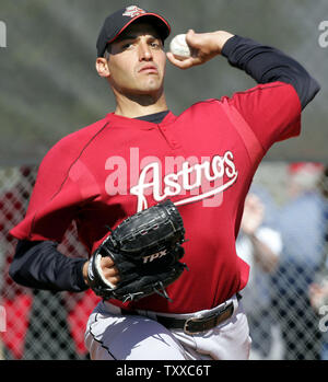 Houston Astros pitcher Andy Pettitte wipes his face with his jersey after  giving up a three-run homer to Los Angeles Dodgers' Nomar Garciaparra in  the third inning of a baseball game in