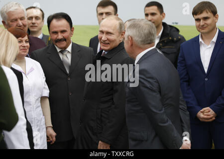 Russian President Vladimir Putin smiles as he visits National Grain Center in Krasnodar, 750 ml south from Moscow, on March 12, 2018 six days ahead of presidential elections in Russia. Photo by Yuri Gripas/UPI Stock Photo