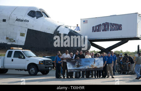 NASA team members and technicians meet space shuttle 'Atlantis' on   runway 15 at the  Kennedy Space Center on July 21, 2011. Atlantis and her crew landed at the Spaceport earlier, ending the shuttle program's thirty year program. Atlantis will be powered down and 'safed' prior to being put on display at the Kennedy Space Center Visitor Complex. Atlantis completed her 33rd and the shuttle program's 135th and final mission with a  predawn landing. Atlantis flew to the International Space Station on mission STS 135 and provided equipment and supplies for the next year.         UPI/Joe Marino-Bil Stock Photo