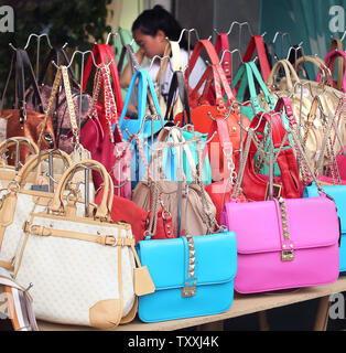 Fake luxury purses are sold on a sidewalk in downtown Guiyang, the capital  of China's Guizhou Province, on May 2, 2015. China remains the largest  manufacturer and supplier of counterfeit luxury goods