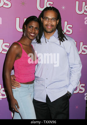Omarosa Manigault-Stallworth of the 'Apprentice' , left, and her husband, Aaron Stallworth, poses for photographers at the Us Weekly Hot Young Hollywood Party at the Spider Club in Los Angeles, Sept. 17, 2004. (UPI Photo/Francis Specker) Stock Photo