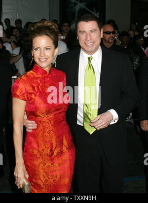 Actor John Travolta, right, and his wife, Kelly Preston poses for photographers at the premiere of the film, 'Ladder 49'  at The El Capitan Theatre  in Los Angeles, September 14, 2004. The Touchstone Pictures movie stars Travolta and opens in the US October 1st. (UPI Photo/Francis Specker) Stock Photo