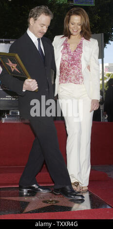 Academy Award winning actor Kevin Kline and actress Sigourney Weaver dance on Kline's star on the Hollywood Walk of Fame in Hollywood, California December 3, 2004. Kline, whose star appears in front of the Hollywood Roosevelt Hotel, won an Oscar in 1988 for his role in 'A Fish Called Wanda.'  (UPI Photo/Jim Ruymen) Stock Photo