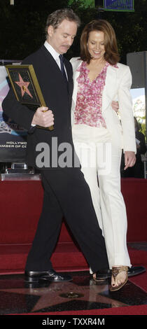 Academy Award winning actor Kevin Kline and actress Sigourney Weaver dance on Kline's star on the Hollywood Walk of Fame in Hollywood, California December 3, 2004. Kline, whose star appears in front of the Hollywood Roosevelt Hotel, won an Oscar in 1988 for his role in 'A Fish Called Wanda.'  (UPI Photo/Jim Ruymen) Stock Photo