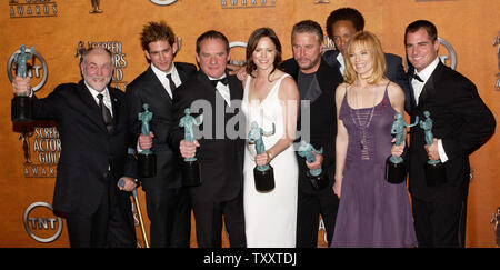 Cast members of the television series 'CSI Crime Scene Investigation,' Robert David Hall, Eric Szmanda, Paul Guilfoyle, Jorja Fox, William Peterson ,Gary Dourdan, Marg Helgenberger and George Eads (L-R), hold the Actor statuettes they won for outstanding performance by an ensemble cast in television drama series during the 11th annual Screen Actors Guild Awards at the Shrine Auditorium in Los Angeles February 5, 2005.    (UPI Photo/Jim Ruymen) Stock Photo