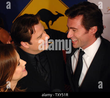 Actor John Travolta and his wife, actress Kelly Preston share a light moment with Australian actor Hugh Jackman during the Penfolds Icon Gala Dinner at the Hollywood Palladium in Los Angeles, California January 14, 2006. The event brings together and honors Australians who have made significant international contributions across various industries. Newton-John received the Lifetime Achievement award.   (UPI Photo/Jim Ruymen) Stock Photo