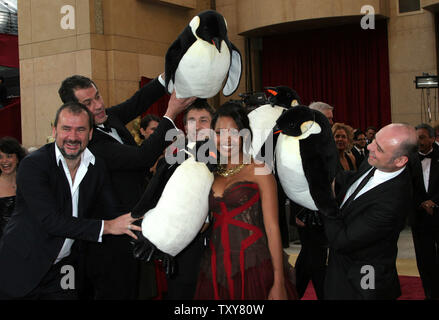 Terry Pheto of the foreign film 'Tsotsi' from South Africa jokes around with the makers of 'March of the Penguins' during arrivals for the 78th Annual Academy Awards at the Kodak Theatre in Hollywood, Ca., on March 5, 2006.   (UPI Photo/David Silpa) Stock Photo