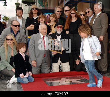 Three-time Grammy-winning music producer of 18 Gold and Platinum albums Lou Adler  (center, holding plaque), who launched 'The Rocky Horror Picture Show' into cult status watches his 4-year-old son Pablo bolt past his just unveiled star on the Hollywood Walk of Fame during a ceremony in Los Angeles, California on April 6, 2006. Surrounding Adler are family members, back row from left, sons Nic, Cisco, friends Herb Alpert and Jerry Moss, wife Page Hannah, second row from left actor Jack Nicholson, sons Ike and Manny, and bottom row, actress Daryl Hannah and son Oscar. (UPI Photo/Jim Ruymen) Stock Photo