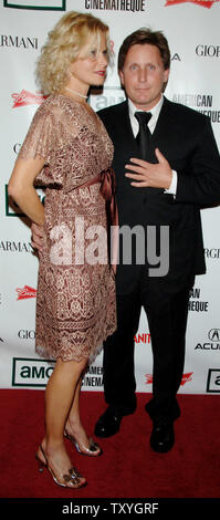 Actor and director Emilio Estevez (R) and fiancee Sonja Magdevski arrive at the American Cinematheque annual benefit gala in Beverly Hills, California on October 13, 2006. Actor George Clooney was honored with the 21st American Cinematheque Award at the gala. (UPI Photo/Jim Ruymen) Stock Photo