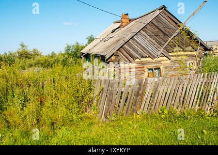 old dilapidated residential house in the village in russian siberia on summer