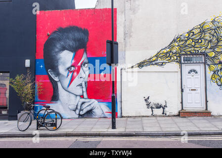 Mural street art graffiti representing David Bowie on a Ada street near Broadway Market, East London, England, UK