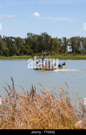 Commercial fishing vessel returning to harbour in Steveston British Columbia Canada Stock Photo