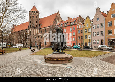 Gdansk, Poland - Feb 14, 2019: View at the medieval knight, warrior monument and St Nicholas catholic church in Gdansk, Poland. Stock Photo