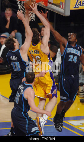 Los Angeles Lakers' Pau Gasol splits Utah Jazz's Mehmet Okur (13) and Paul Millsap (24) to score in Game 2 of the Western Conference semifinals in Los Angeles on May 7, 2008. The Lakers defeated the Jazz 120-110 to lead the best-of-seven playoff series 2-0. (UPI Photo/Shotaro Yamada) Stock Photo
