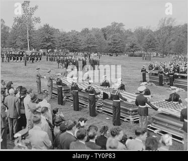 Distance view of President Truman attending the burial of twenty soldiers at Arlington National Cemetery. These twenty were the first war dead now returned to be buried in their native land. Stock Photo