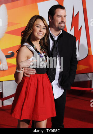 Actress and singer Miley Cyrus (L) and actor John Travolta, who provide voice work in the animated film 'Bolt', attend the premiere of the film at the El Capitan Theatre in the Hollywood section of Los Angeles on November 17, 2008. (UPI/Photo/Jim Ruymen) Stock Photo