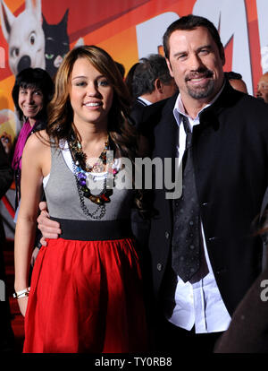 Actress and singer Miley Cyrus (L) and actor John Travolta, who provide voice work in the animated film 'Bolt', attend the premiere of the film at the El Capitan Theatre in the Hollywood section of Los Angeles on November 17, 2008. (UPI/Photo/Jim Ruymen) Stock Photo