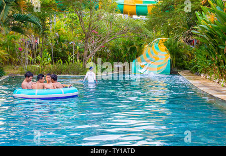 Yogyakarta, Java, Indonesia - 12 June 2019: Young people enjoying themselves on a slide at a waterpark Stock Photo