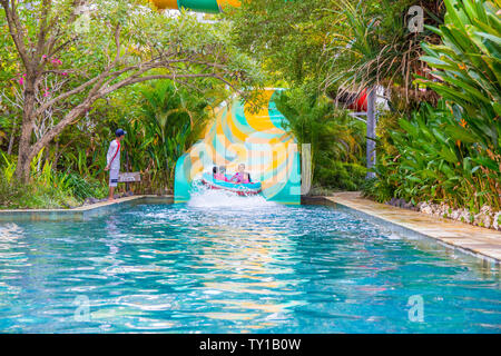 Yogyakarta, Java, Indonesia - 12 June 2019: Young people enjoying themselves on a slide at a waterpark Stock Photo