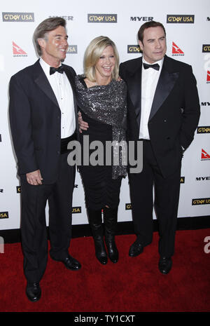 Olivia Newton-John (C), her husband John Easterling (L) and John Travolta arrive on the red carpet at the G'Day USA 2010 Los Angeles Black Tie Gala in Hollywood on January 16, 2010.  The event honors high profile individuals for significant contributions to their industries and for excellence in promoting Australia in the United States.   (UPI/David Silpa) Stock Photo
