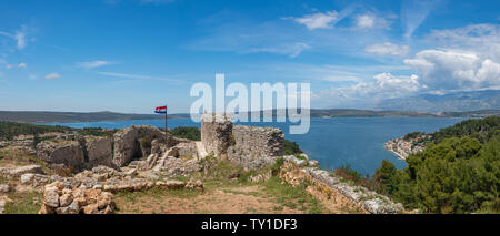 Flag on top of fortress above the Croatian town of Novigrad in Istria County Stock Photo