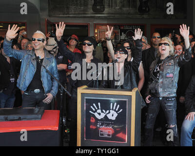 The German rock band The Scorpions, from left, Rudolf Schenker, Matthias Jabs, Klaus Meine and James Kottak address the crowd as they are inducted into the Hollywood Rockwalk in Los Angeles, Tuesday, April 6, 2010. Hidden behind Meine and Kottak is fellow band member Pawel Maciwoda.  UPI/Jim Ruymen Stock Photo