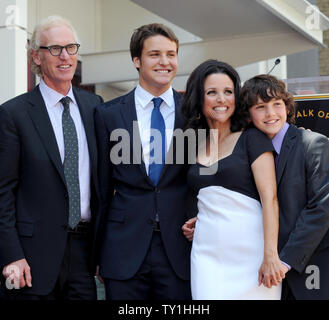 Actress Julia Louis-Dreyfus (3rd-L) stands next to her star in front of the W Hotel, with husband Brad Hall (L), and their sons Henry (2nd-L) and Charlie (R) during an unveiling ceremony honoring her with the 2,407th star on the Hollywood Walk of Fame in Los Angeles on May 4, 2010.     UPI/Jim Ruymen