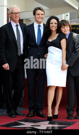 Actress Julia Louis-Dreyfus (3rd-L) stands next to her star in front of the W Hotel, with husband Brad Hall (L), and their sons Henry (2nd-L) and Charlie (R) during an unveiling ceremony honoring her with the 2,407th star on the Hollywood Walk of Fame in Los Angeles on May 4, 2010.     UPI/Jim Ruymen
