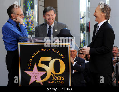 Comedian and television host Bill Maher (R) and CNN talk show host Larry King (L) wait for Hollywood Chamber of Commerce president and CEO Leron Gubler (C) to finish his introduction of King at ceremonies unveiling Maher's star on the Hollywood Walk of Fame in Los Angeles on September 14, 2010.     UPI/Jim Ruymen Stock Photo