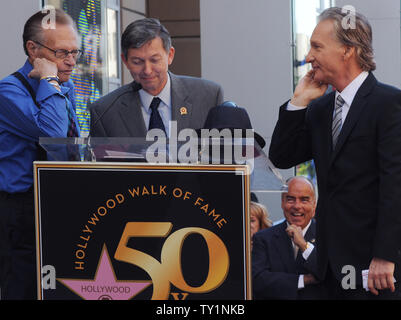 Comedian and television host Bill Maher (R) and CNN talk show host Larry King (L) wait for Hollywood Chamber of Commerce president and CEO Leron Gubler (C) to finish his introduction of King at ceremonies unveiling Maher's star on the Hollywood Walk of Fame in Los Angeles on September 14, 2010.     UPI/Jim Ruymen Stock Photo