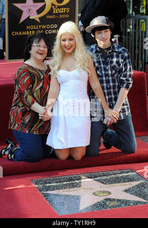 Singer and actress Christina Aguilera (C) poses with her mother Shelly and brother Michael during a ceremony unveiling her star on the Hollywood Walk of Fame in Los Angeles on November 15, 2010. Aguilera stars in the upcoming film 'Burlesque'', directed by Steve Antin.   UPI/Jim Ruymen Stock Photo