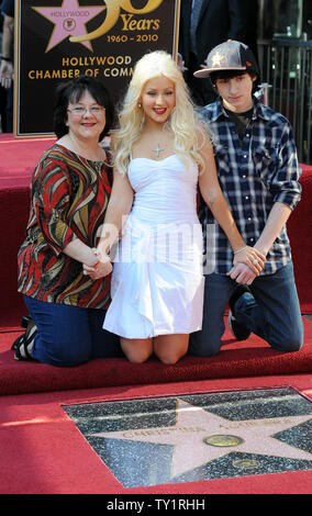 Singer and actress Christina Aguilera (C) poses with her mother Shelly and brother Michael during a ceremony unveiling her star on the Hollywood Walk of Fame in Los Angeles on November 15, 2010. Aguilera stars in the upcoming film 'Burlesque'', directed by Steve Antin.   UPI/Jim Ruymen Stock Photo