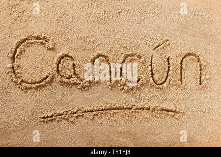 Cancun Mexico beach word written in sand Stock Photo