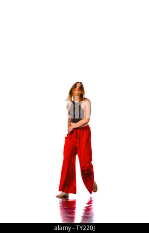 Stylish female hip hop dancer in dancing pose posing in studio. Exercise, gym, sport Stock Photo