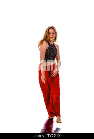 Happy girl working out dance standing with hands up. Dynamic woman fitness trainer dancing for fun Stock Photo