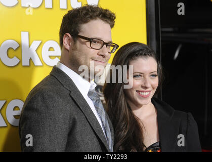 Cast member Seth Rogen (L) and guest attend the premiere of 'Paul' held at Grauman's Chinese Theatre in the Hollywood section of Los Angeles on March 14, 2011.     UPI/Phil McCarten Stock Photo