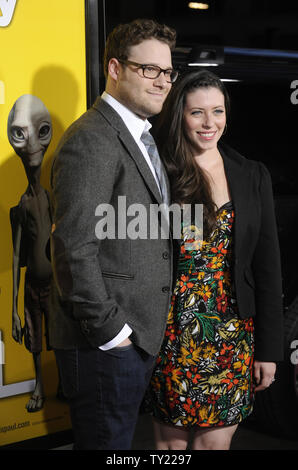 Cast member Seth Rogen (L) and guest attend the premiere of 'Paul' held at Grauman's Chinese Theatre in the Hollywood section of Los Angeles on March 14, 2011.     UPI/Phil McCarten Stock Photo