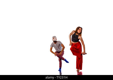 Teenagers skill and talent of modern dance, dancing in studio over white background Stock Photo
