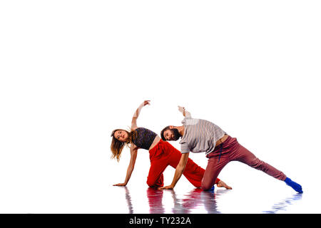 Teenagers skill and talent of modern dance, dancing in studio over white background Stock Photo