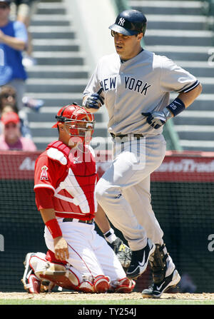New York Yankees'  Mark Teixeira (25) hits a two run home run in the third inning as Los Angeles Angels catcher Hank Conger, watches,  at Angel Stadium in Anaheim, California on June 5, 2011.  The Yankees won 5-3.  UPI/Lori Shepler. Stock Photo