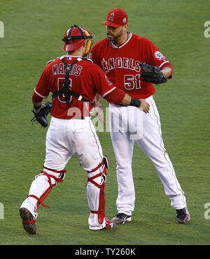 San Diego Padres' Adrian Gonzalez, right, is greeted at the dugout steps by  Dave Roberts after hitting a home run off Los Angeles Angels pitcher Jeff  Weaver in the sixth inning of