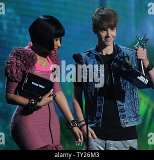 Singer Justin Bieber (R) accepts the best male hip hop artist for Kanye West from co-presenter Nicki Minaj during the 2011 BET Awards at the Shrine Auditorium in Los Angeles on June 26, 2011.  UPI/Jim Ruymen Stock Photo