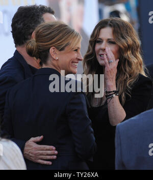 Director/writer/producer/actor Tom Hanks (L), greets his co-star, actress Julia Roberts (C) as his wife and cast member Rita Wilson (R) looks on during the premiere of the motion picture romantic comedy drama 'Larry Crowne', at Grauman's Chinese Theatre in the Hollywood section of Los Angeles on June 27, 2011.    UPI/Jim Ruymen Stock Photo